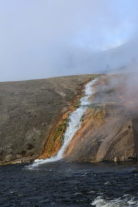 A stream of steaming water flanked on both sides by vibrant orange.